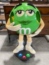 Green M&M Candy Plastic Store Rolling Display Stand. Very Good Condition. See pics.
