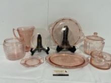 Collection of Pink Depression Glass, Pitcher, Lidded Jars, Serving Plates, & more