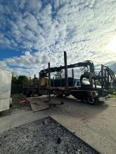 8 Bunk Tandem Spread Axle Log Trailer With Mid-Mounted Hood 7000 Knuckle Boom Loader. Located At 160