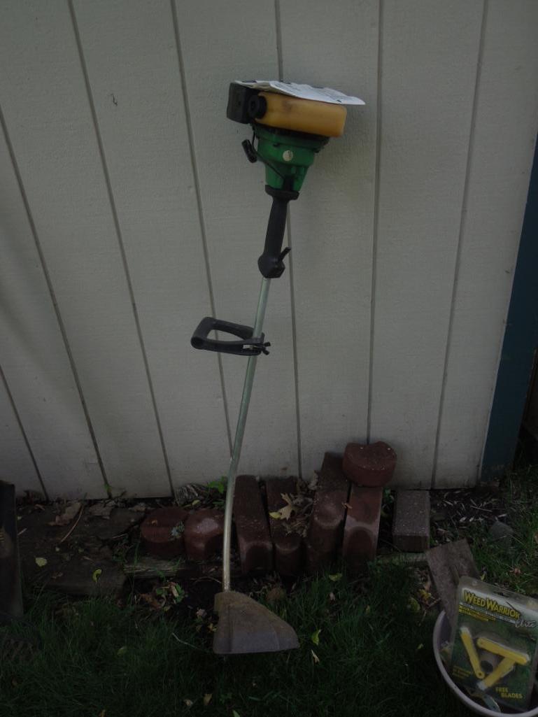 Gas weed eater with tub of gardening clippers