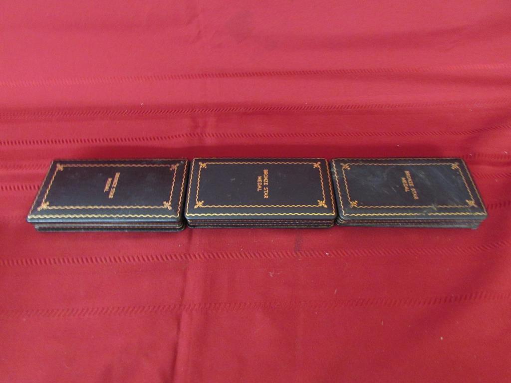 3 Bronze star medals in cases.