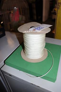 Spool of white string with 5 mini golf tee mats