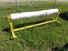 Metal frame w/wheels w/roll of clear plastic