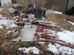 Misc scrap iron and parts, located around the exterior of building, also in