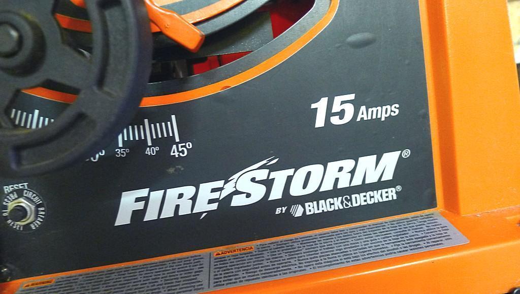 Black and Decker FireStorm 10" table saw with steel floor stand and dust collection bag. Table with