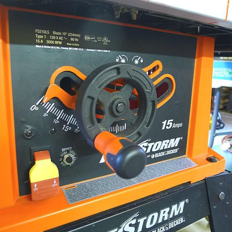 Black and Decker FireStorm 10" table saw with steel floor stand and dust collection bag. Table with