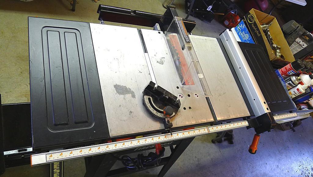 Black and Decker FireStorm 10" table saw with steel floor stand and dust collection bag. Table with