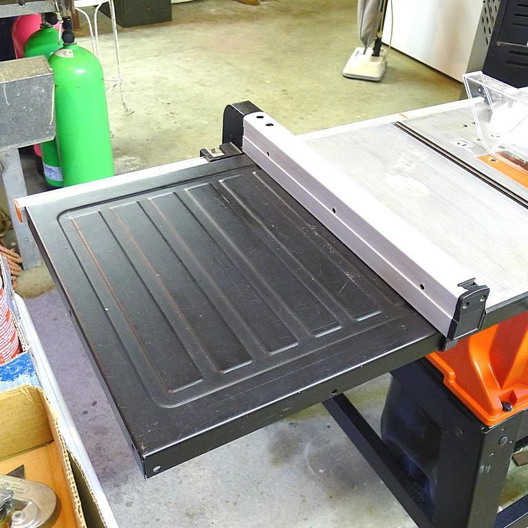 Black and Decker FireStorm 10" table saw with steel floor stand and dust collection bag. Table with