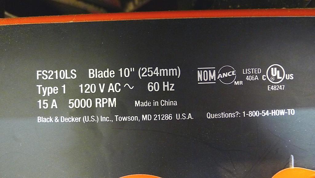 Black and Decker FireStorm 10" table saw with steel floor stand and dust collection bag. Table with