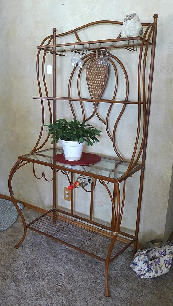 Metal framed wine rack with two glass shelves and a bottom wire shelf. Approx. 6' tall x 3' wide x