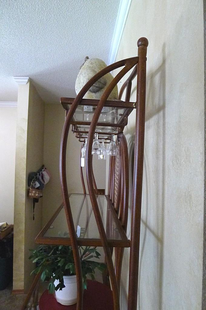 Metal framed wine rack with two glass shelves and a bottom wire shelf. Approx. 6' tall x 3' wide x