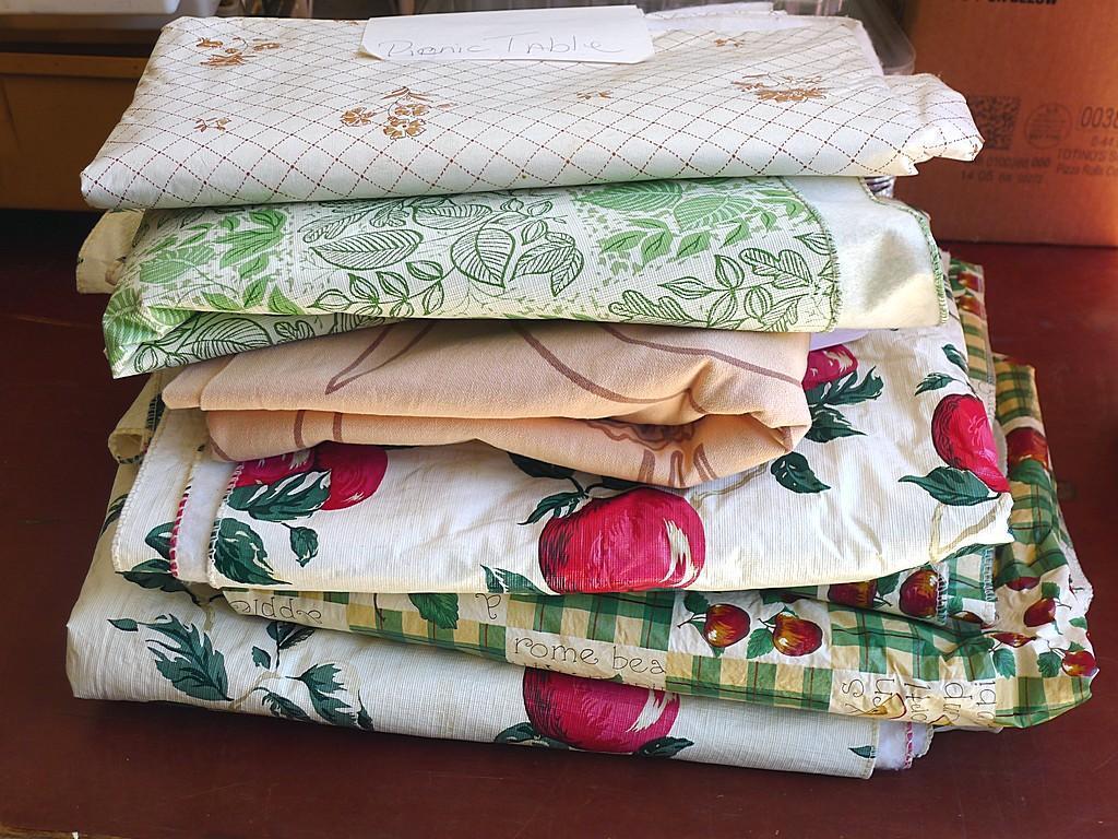 Rubbermaid 5 gallon water cooler, assorted vinyl tablecloths and one more. Some tablecloths have