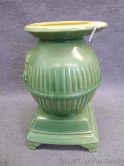 Red Wing art pottery pot belly stove planter is marked on bottom '765'. Planter stands 8" tall and