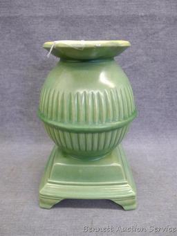 Red Wing art pottery pot belly stove planter is marked on bottom '765'. Planter stands 8" tall and