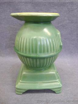 Red Wing art pottery pot belly stove planter is marked on bottom '765'. Planter stands 8" tall and