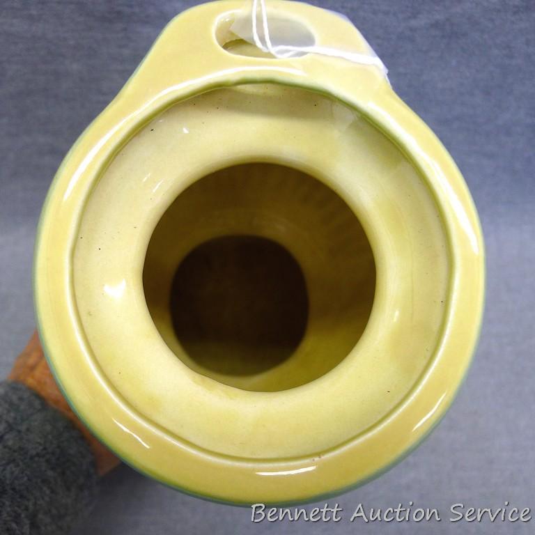 Red Wing art pottery pot belly stove planter is marked on bottom '765'. Planter stands 8" tall and