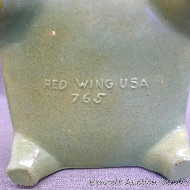 Red Wing art pottery pot belly stove planter is marked on bottom '765'. Planter stands 8" tall and