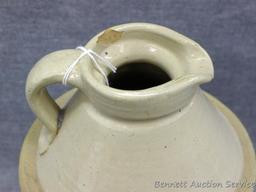 Stoneware syrup pitcher stands approx. 8-1/2" tall and is in overall good condition with only one