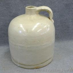 One gallon stoneware bee hive jug stands nearly 9" tall. In overall good condition with a hairline