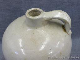 One gallon stoneware bee hive jug stands nearly 9" tall. In overall good condition with a hairline