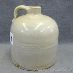 One gallon stoneware bee hive jug stands nearly 9" tall. In overall good condition with a hairline