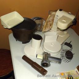 West Bend food processor includes meat grinder, cutting discs, and whisk attachments. Powers up.