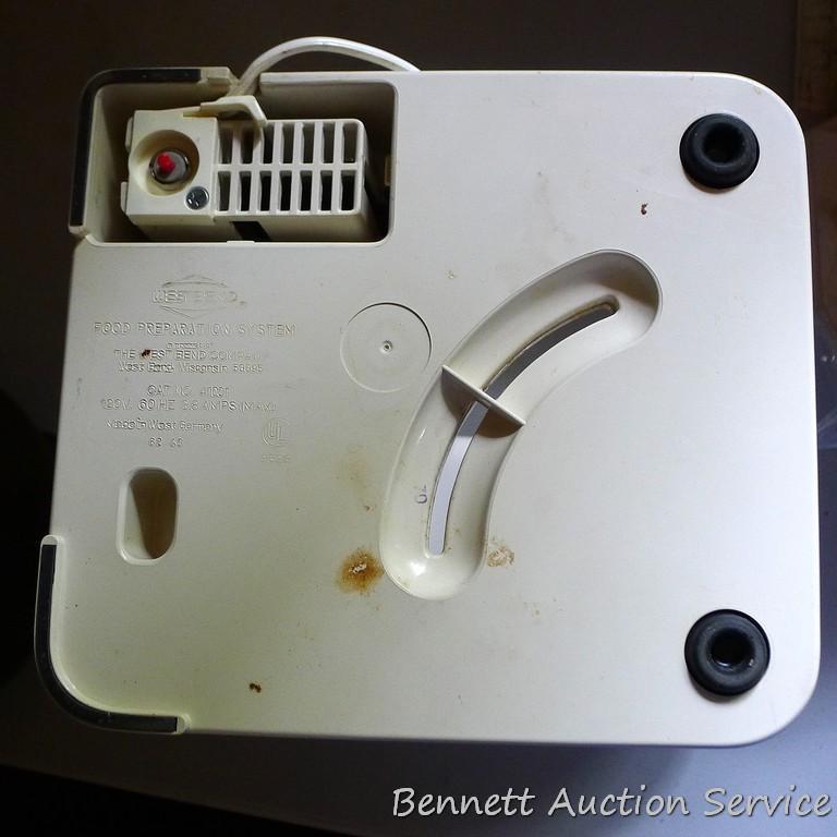 West Bend food processor includes meat grinder, cutting discs, and whisk attachments. Powers up.