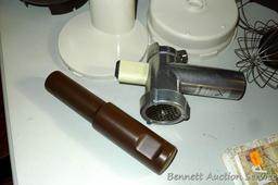 West Bend food processor includes meat grinder, cutting discs, and whisk attachments. Powers up.