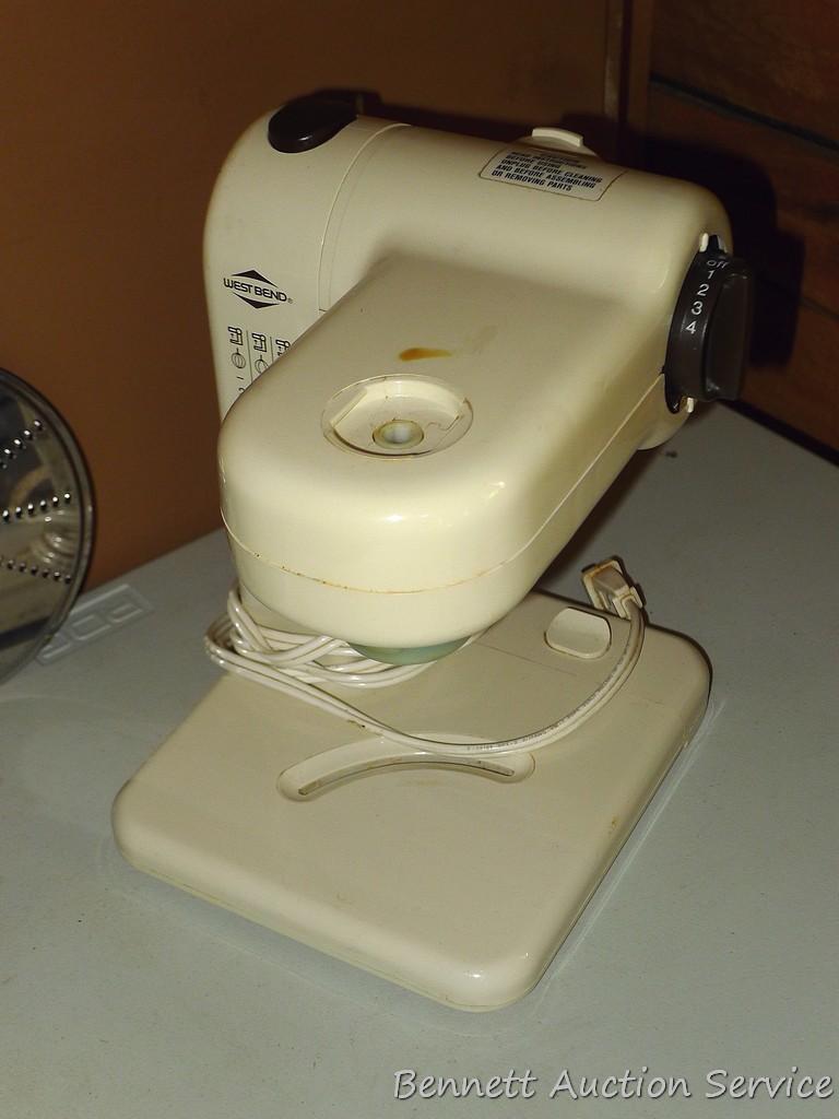 West Bend food processor includes meat grinder, cutting discs, and whisk attachments. Powers up.