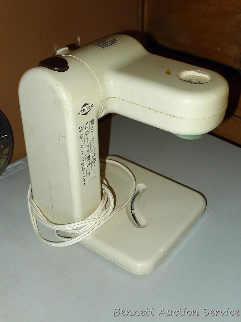 West Bend food processor includes meat grinder, cutting discs, and whisk attachments. Powers up.