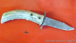 Knife with antler handle, 7" long; well used knife in leather sheaf.