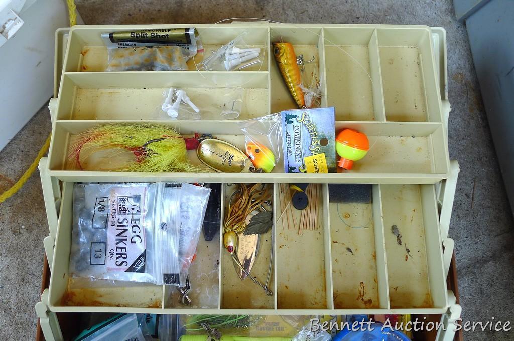 Plano tackle box filled with sinkers, bobbers and fishing lures and more.