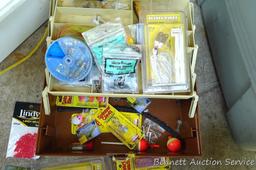 Plano tackle box filled with sinkers, bobbers and fishing lures and more.