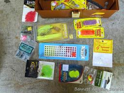 Plano tackle box filled with sinkers, bobbers and fishing lures and more.