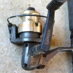 Three fishing rods with reels. One Fenwick rod 78" tall with a Quantam reel, one Quantam rod 74"