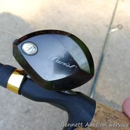 Two fishing rods with reels. One Cabela's Tourney Trail IM7 rod, one Mitchell graphite rod. One has