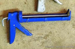 Pair of caulking guns for standard tubes; one gun for large tubes.