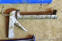 Pair of caulking guns for standard tubes; one gun for large tubes.