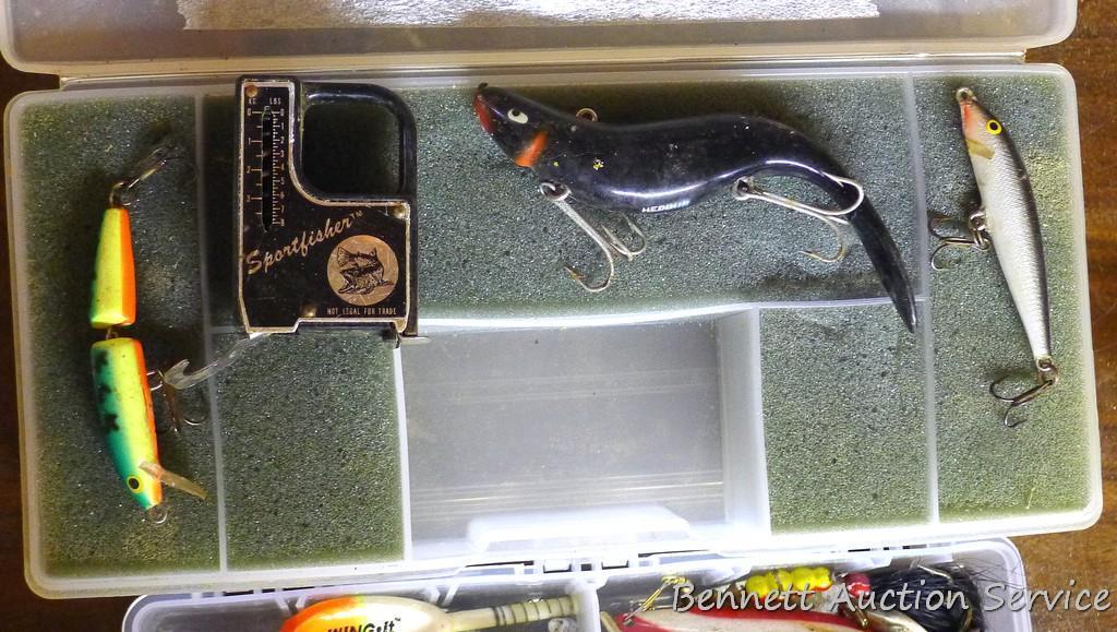 Three plastic bait boxes filled with baits; fishing scale largest box is 10" x 4" x 2".