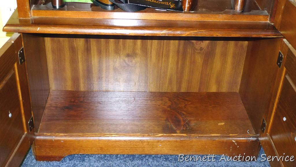 Wooden gun cabinet with two locking storage areas and etched glass door is approx. 29" x 11" x 72"