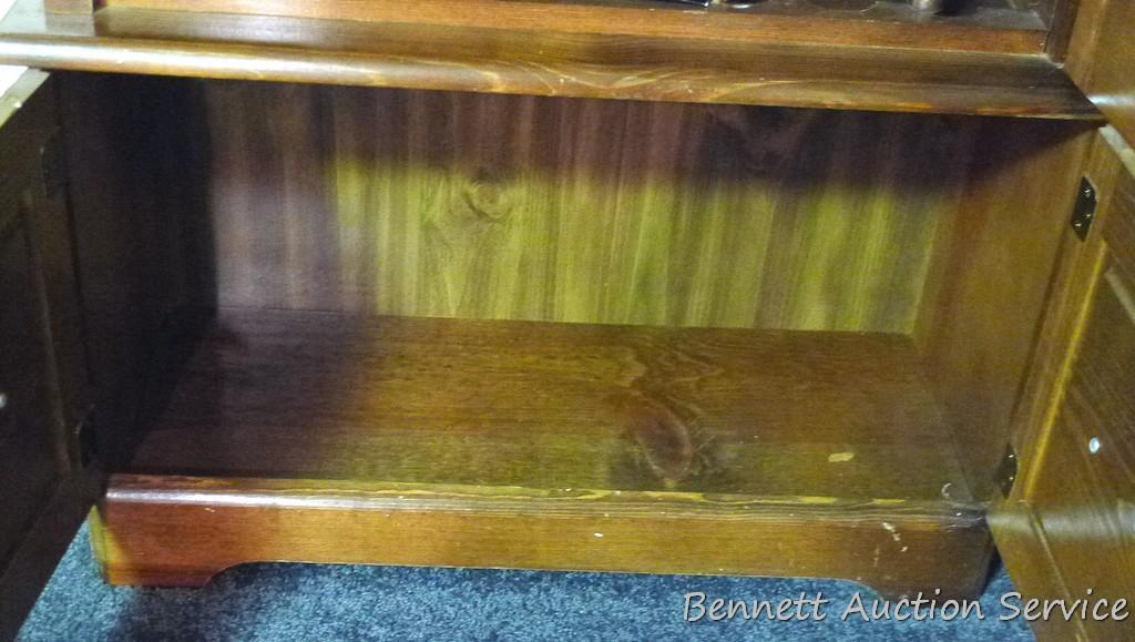 Wooden gun cabinet with two locking storage areas and etched glass door is approx. 29" x 11" x 72"