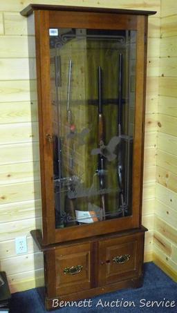 Wooden gun cabinet with two locking storage areas and etched glass door is approx. 29" x 11" x 72"