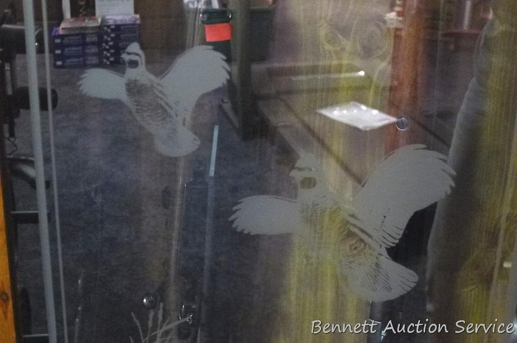 Wooden gun cabinet with two locking storage areas and etched glass door is approx. 29" x 11" x 72"