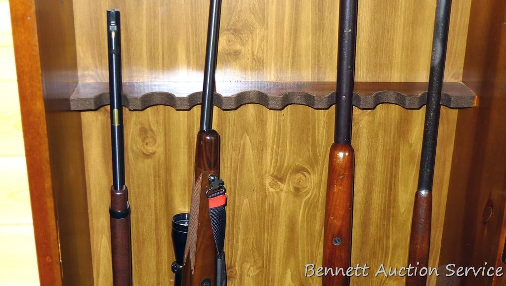 Wooden gun cabinet with two locking storage areas and etched glass door is approx. 29" x 11" x 72"