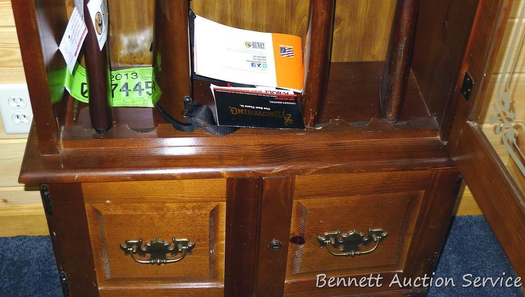 Wooden gun cabinet with two locking storage areas and etched glass door is approx. 29" x 11" x 72"