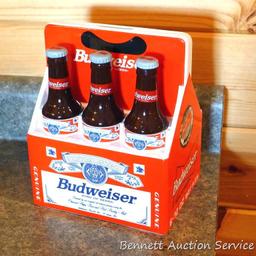 1998 Budweiser ceramic coin bank with some contents. Stands nearly 8" high.
