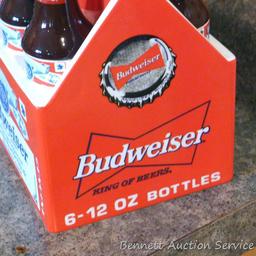 1998 Budweiser ceramic coin bank with some contents. Stands nearly 8" high.
