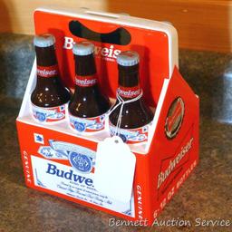 1998 Budweiser ceramic coin bank with some contents. Stands nearly 8" high.