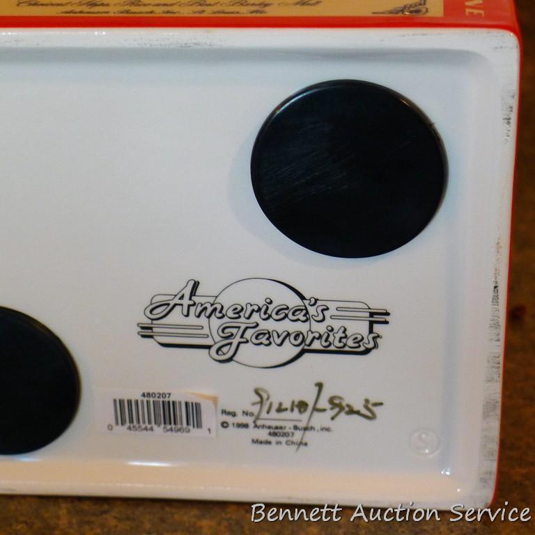 1998 Budweiser ceramic coin bank with some contents. Stands nearly 8" high.