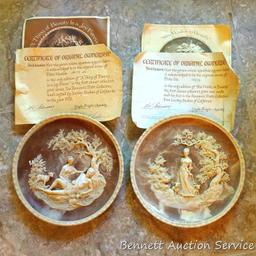 Two Incolay collector's plates with certificates of original ownership. One titled 'She Walks in
